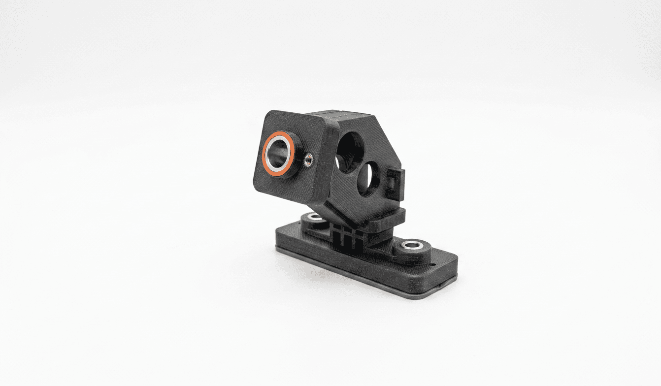 3D-printed sensor retrofit bracket with an orange datum ring and an angled sensor head